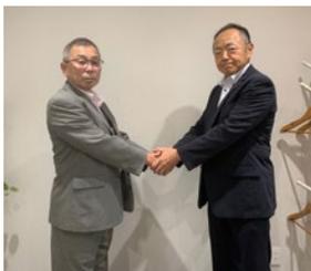 鈴木文三社長（右）と株式会社ビーエス静岡 古屋学社長（左）の握手。
